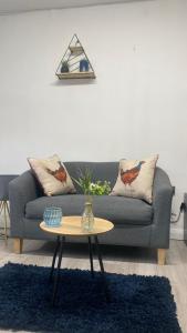 a living room with a couch and a table at BV Royal Comfy Studio Seven Suite Queensgate Huddersfield in Huddersfield