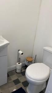 a bathroom with a white toilet and a sink at BV Royal Comfy Studio Seven Suite Queensgate Huddersfield in Huddersfield