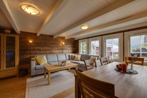 a living room with a couch and a table at Flotunet - Anestova in Stryn