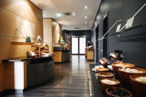 a restaurant with a buffet line with bowls of food at Ramada by Wyndham Essen in Essen