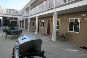 a patio with a grill and a table and chairs at Affordable Suites - Fayetteville/Fort Bragg in Fayetteville