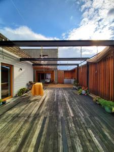 a patio with a wooden floor and a building at VIGEO lounge b&b coffee in Bojnice