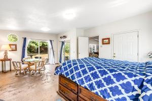 a bedroom with a bed and a table and chairs at Mendocino Dunes - Sand Dollar in Fort Bragg