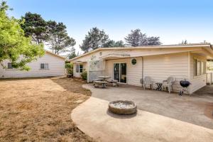 a house with a patio and a grill at Mendocino Dunes - Sand Dollar in Fort Bragg