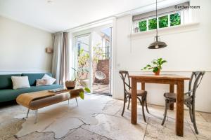 a living room with a table and a couch at Boutique hotel Villa Oldenhoff in Abcoude