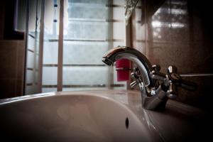 a bathroom sink with a faucet and a window at Villa Evelyn in Stafylos +43 photos