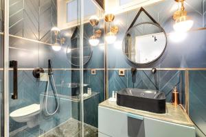 a bathroom with a sink and a mirror at CMG Marais/ Republique F in Paris