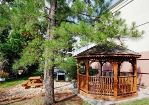 a gazebo in a yard next to a tree at Sonesta Simply Suites Knoxville in Knoxville
