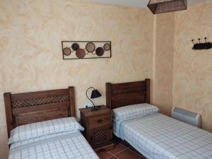 A bed or beds in a room at Casa Rural La Torreta en El Rincón de Ademuz