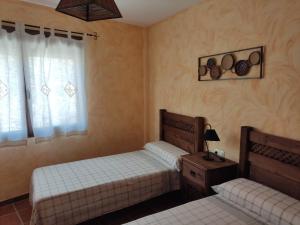 A bed or beds in a room at Casa Rural La Torreta en El Rincón de Ademuz