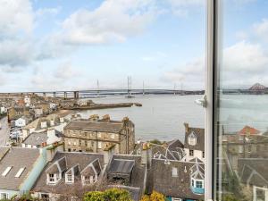 a view of the river thames and a bridge from a window at Forth Reflections in Queensferry