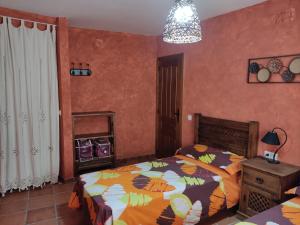 A bed or beds in a room at Casa Rural La Torreta en El Rincón de Ademuz