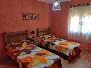 A bed or beds in a room at Casa Rural La Torreta en El Rincón de Ademuz