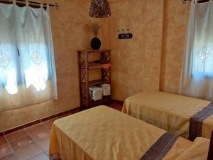 A bed or beds in a room at Casa Rural La Torreta en El Rincón de Ademuz