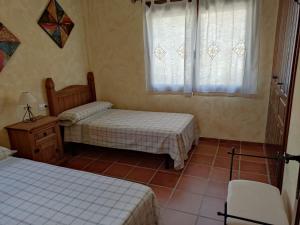 A bed or beds in a room at Casa Rural La Torreta en El Rincón de Ademuz