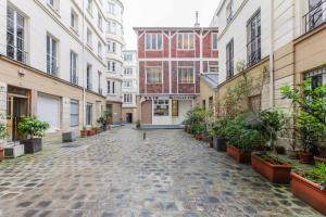 an empty street in a city with buildings at CMG Marais // République G in Paris