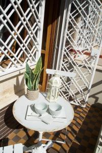 a white table on a balcony with a window at La Première di Maison Home in Lido di Ostia