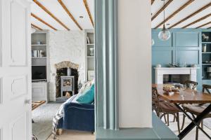 a living room with blue walls and a table at 1 Quayside in Appledore