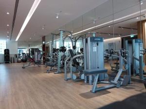 a gym with a row of treadmills and machines at Dream Inn Apartments - Marina Pinnacle in Dubai