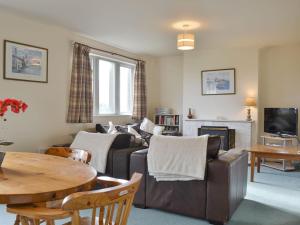 a living room with a couch and a table at Ribblestones in Austwick