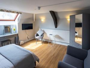 a bedroom with a bed and a desk and a mirror at The Coach House Apartment in Edwinstowe