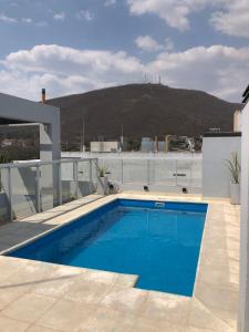 a swimming pool on the roof of a house at Departamento para 3 con parrilla privada y PILETA! in Salta