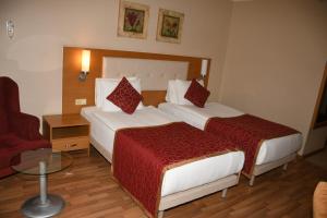 A bed or beds in a room at Alaiye Resort & Spa Hotel - Ultra All Inclusive