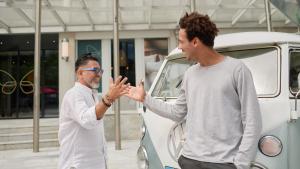 a man giving another man a high five in front of a van at Cocoon Salzburg in Salzburg +56 photos