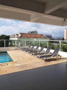 a group of lounge chairs on the roof of a building at Seaview Modern Studio in Sihanoukville