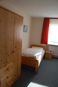 a bedroom with a wooden bed and a window at Hotel Grüner Baum in Bretzenheim +30 photos
