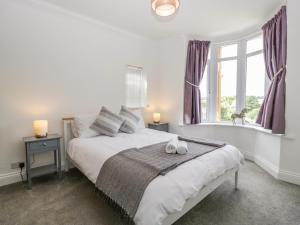a bedroom with a bed with two candles on it at Highbank in Wareham