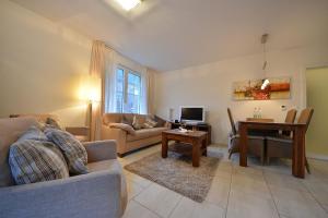 a living room with a couch and a table at Villa Verdi - Ferienwohnung 2 in Wangerooge