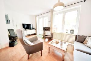 a living room with a couch and a table at Haus Blümlein Wangerooge in Wangerooge