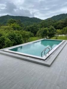 a swimming pool on a roof of a house at Monlada Khaoyai in Mu Si