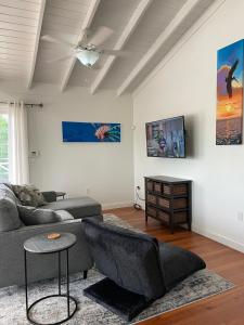 a living room with a couch and a table at Sound of The Sea-walking distance to everything in Placencia Village