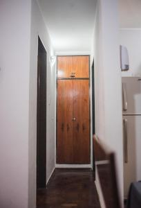 um corredor com uma porta de madeira num quarto em Departamento increíble en Cordoba em Córdoba