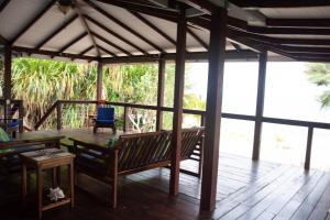 a pavilion with a table and chairs on a deck at Seagrape Escape in Maya Beach