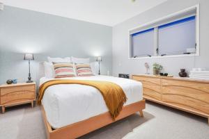 a bedroom with a large bed and a window at Ponsonby Delight with Wi-fi and Free Parking in Auckland