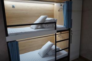 a room with three bunk beds in a room at HostelOne in Ulaanbaatar