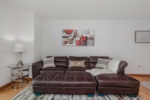 a brown leather couch in a living room at Miami condo with city & ocean views! Sleep up to 6! in Miami