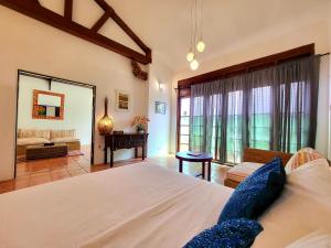 a bedroom with a large bed and a living room at East Indies Mansion in George Town