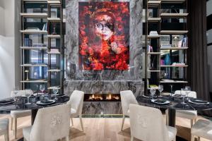 a dining room with a fireplace and a painting of a woman at Grand Hotel Kalamata in Kalamata
