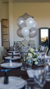 a long table with white balloons on top of it at Morobello in San Marcello