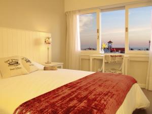 a bedroom with a bed with a view of the ocean at Atlántico Boutique Hotel in Punta del Este