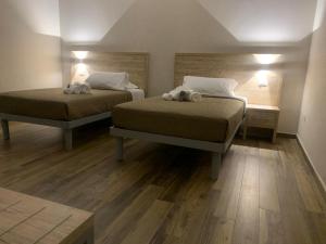 En eller flere senge i et værelse på Masseria Spinale Wine Resort