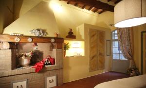 a living room with a brick fireplace and a door at B&B Le Aquile in Siena