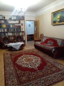 a living room with a couch and a rug at LA's Apartment with closed parking in Alaverdi