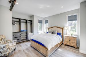 a bedroom with a large bed and a chair at The Qanuk Fernie - Ski In Ski Out in Fernie