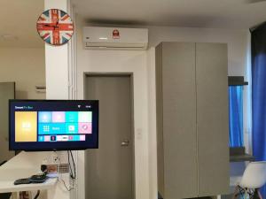 a room with a flat screen tv on a wall at G Studio Swimming Pool View@EVO BANGI NETFLIX+WIFI in Kampong Sungai Ramal Dalam