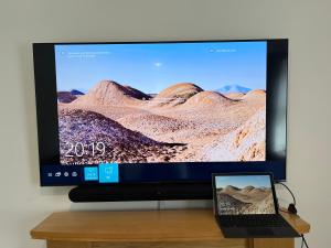 a computer monitor with a laptop on a table at Beautiful 2-Bed Apartment in Poulton-le-Fylde in Poulton le Fylde